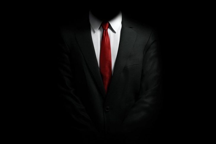 man-with-black-suit-and-red-tie-1024×800